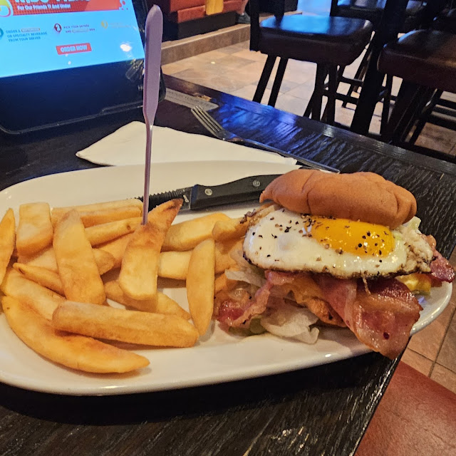 Steak Fries and Grilled Chicken Sandwich with Egg on Top