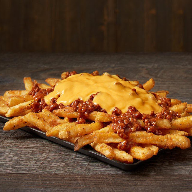 Our Famous Seasoned Fries Topped with Cheese Ranch and Crispy Bacon